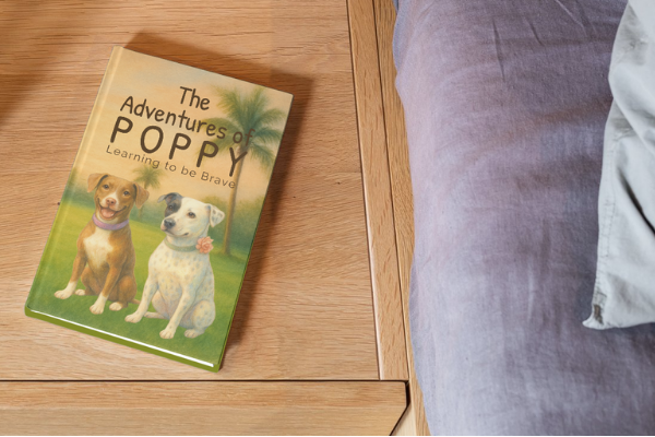 The Adventures of Poppy book displayed on wooden surface with soft natural lighting
