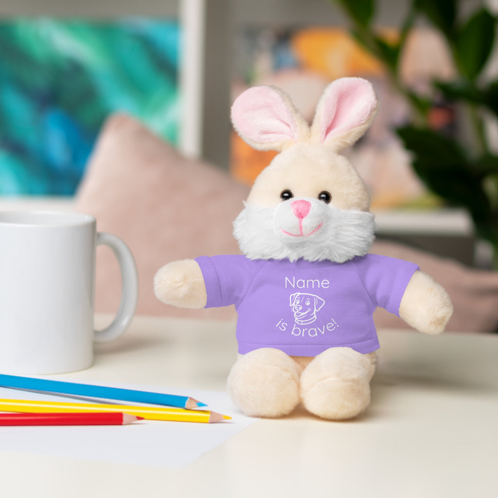Soft off white plush bunny wearing a Name is Brave personalized lavendar  tee shirt - sitting on desk with colored pencils