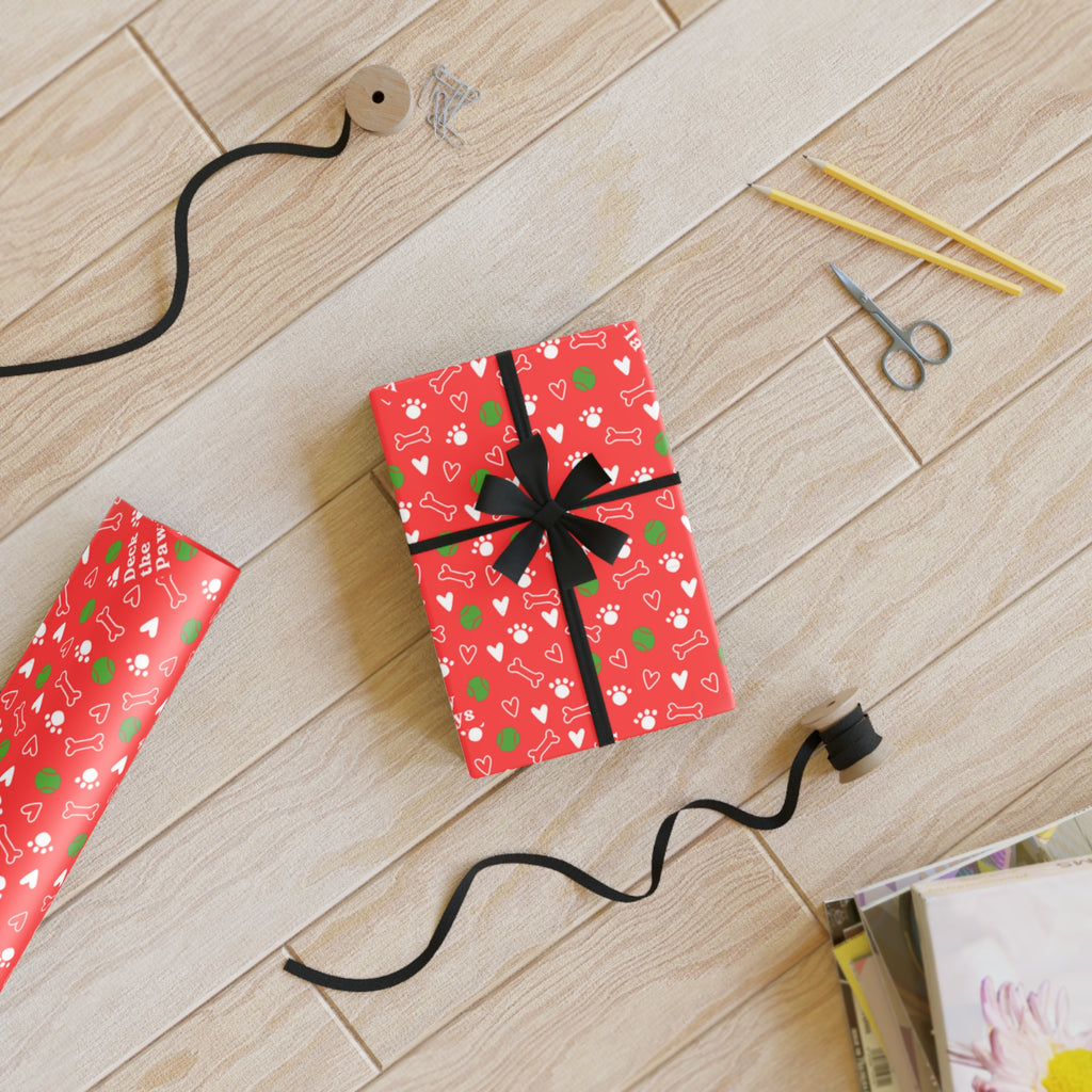 Sheet of festive dog-themed holiday gift wrap unrolled showing full repeat pattern