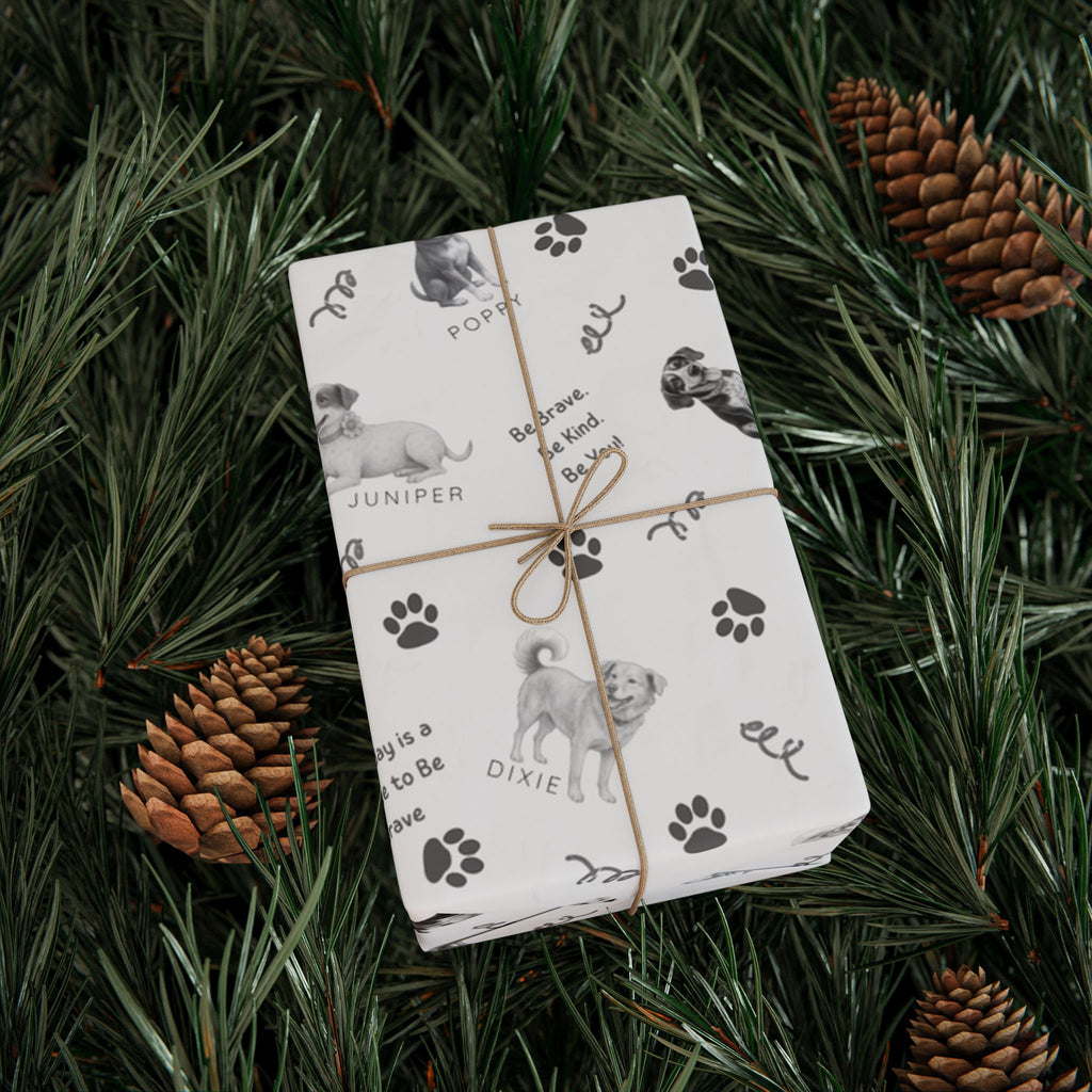 Box wrapped in The Adventures of Poppy neutral holiday wrapping paper in Christmas tree