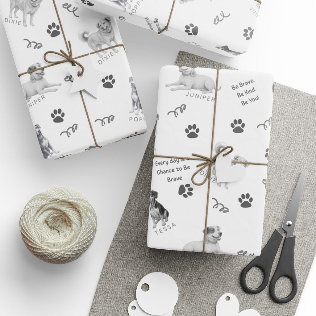 Boxes wrapped in The Adventures of Poppy neutral holiday wrapping paper showing Poppy and Tessa dog character pattern