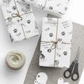 Boxes wrapped in The Adventures of Poppy neutral holiday wrapping paper showing Poppy and Tessa dog character pattern