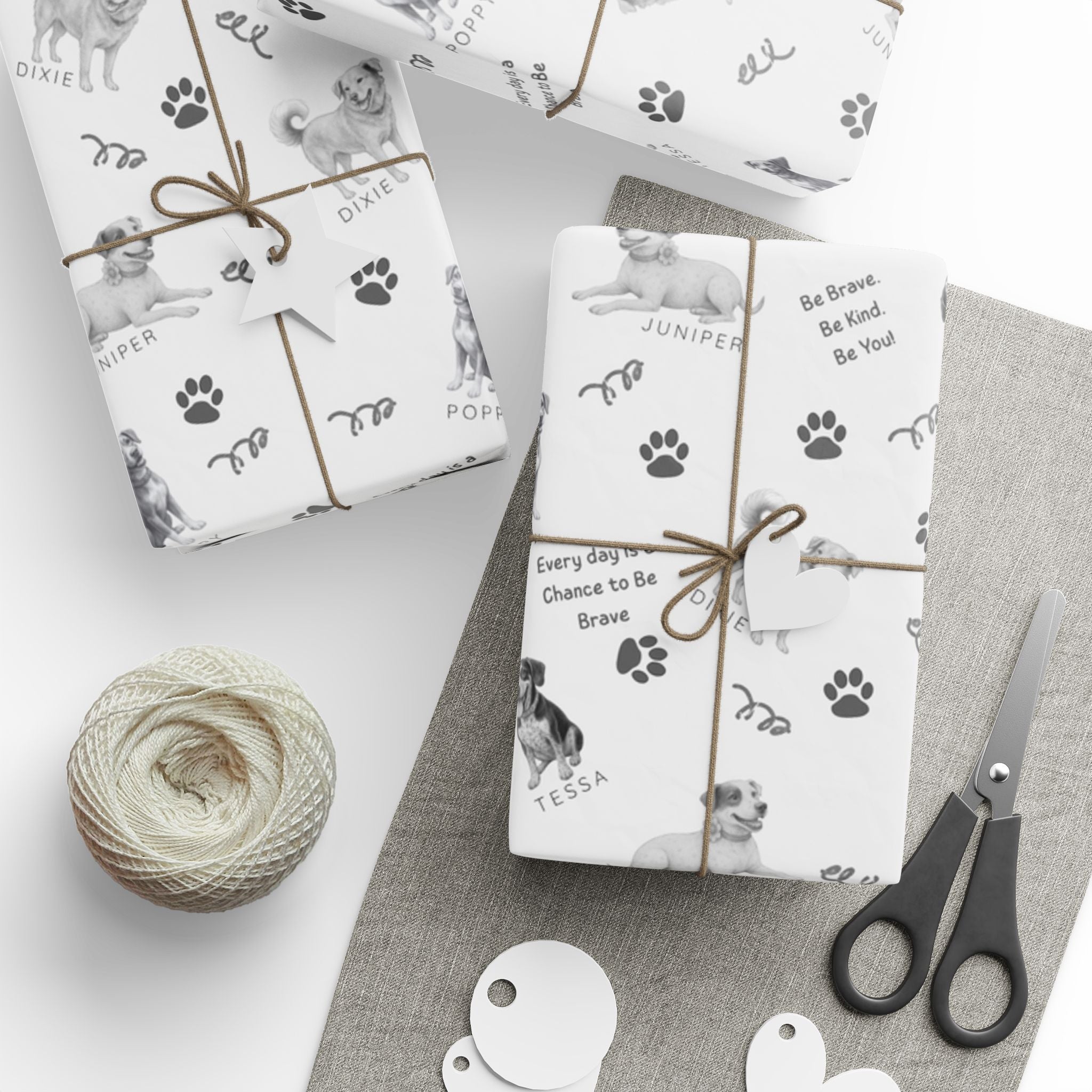 Boxes wrapped in The Adventures of Poppy neutral holiday wrapping paper showing Poppy and Tessa dog character pattern