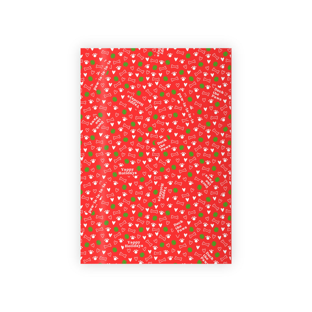 Gift wrapped in Christmas dog paper with bow, on white background