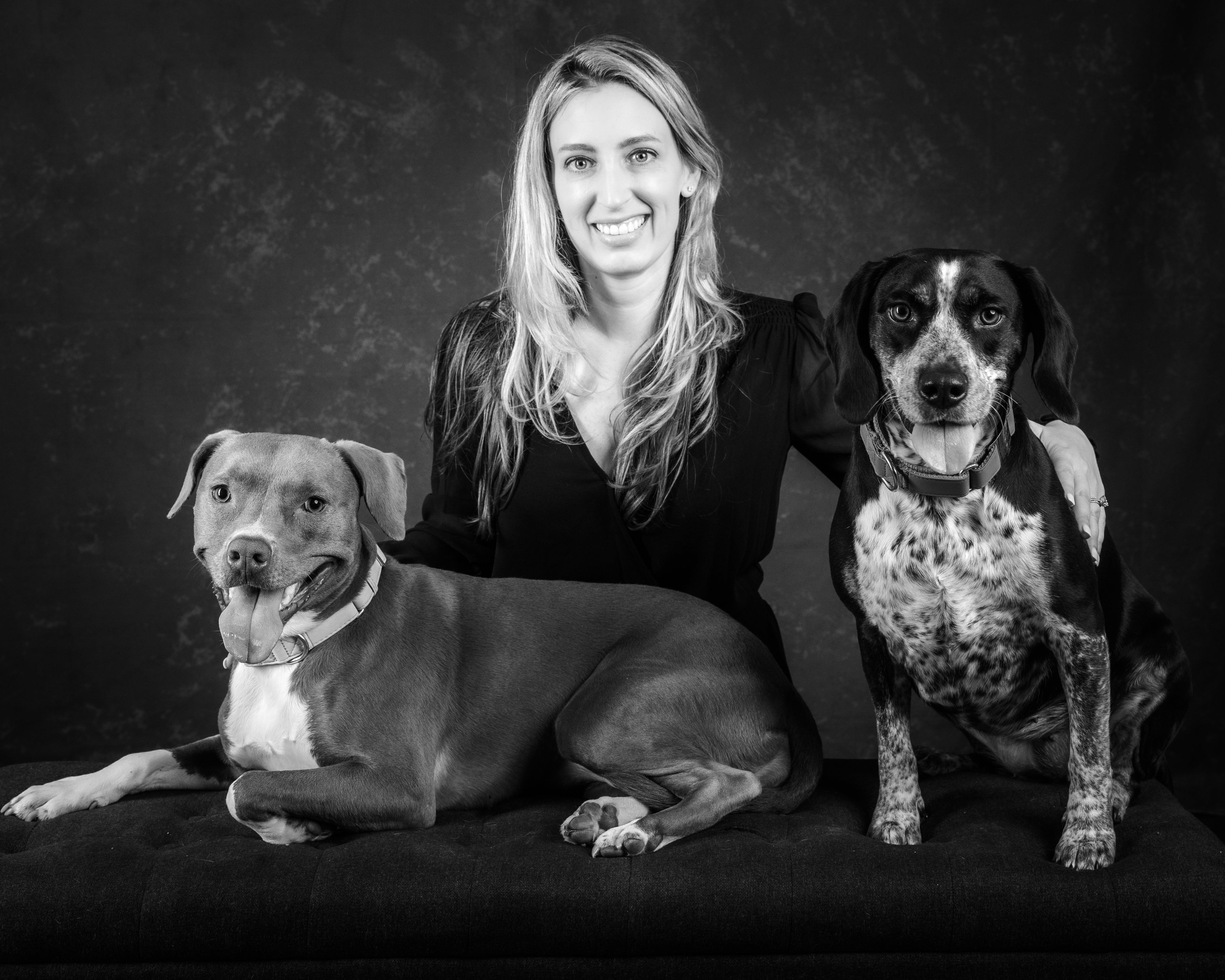 Woman with two dogs on a black background